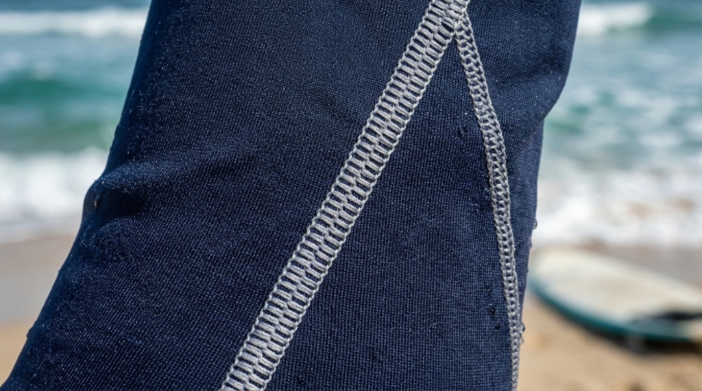 Close-up of flatlock-stitched rash guard fabric designed for rash prevention and surf comfort