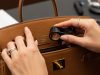Luxury handbag seller inspecting factory stamp in San Francisco