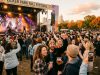 Crowd enjoying live music on stage at Zilker Park during the fall festival