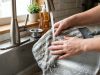 Close-up of a person attaching a microfiber Shark steam mop pad to the cleaning head.