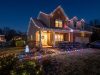 Suburban house decorated with affordable LED Christmas lights during winter evening.