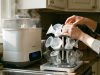 Modern countertop baby bottle washer operating in a bright New York kitchen.