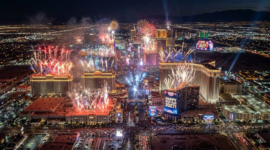 Aerial view of Las Vegas casino rooftops launching fireworks at midnight on January 1 2027